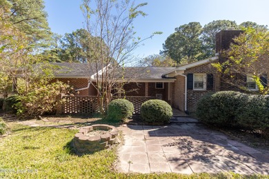 This charming brick ranch stands out on its corner lot within