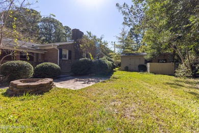 This charming brick ranch stands out on its corner lot within