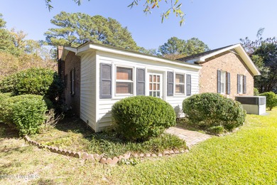 This charming brick ranch stands out on its corner lot within