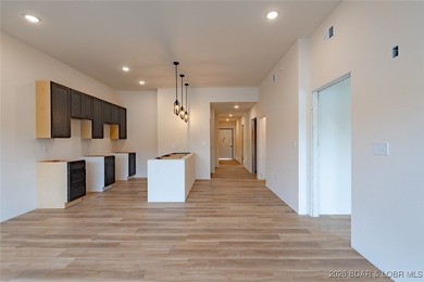 Experience refined lakefront living in this brand-new unit at