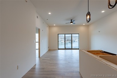 Experience refined lakefront living in this brand-new unit at