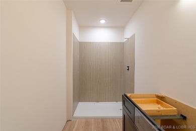 Experience refined lakefront living in this brand-new unit at