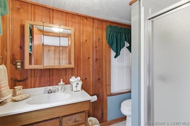 Discover this unique 2-bedroom, 1-bath lakefront cabin offering - photo 18