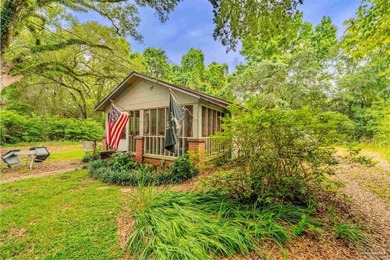 Nestled beneath a canopy of mature oaks and tucked away on a - photo 3