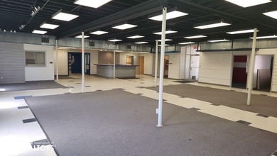 Former equipment dealership building on 1.27 acres at the west