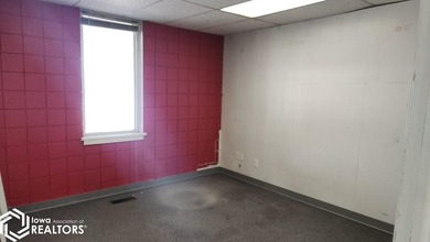 Former equipment dealership building on 1.27 acres at the west