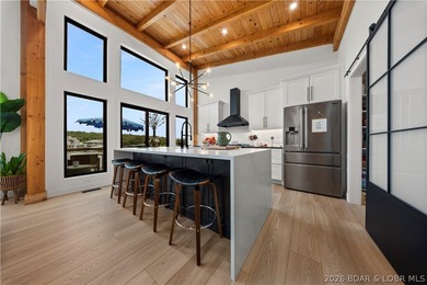 Contemporary luxury meets effortless lake living in this - photo 14