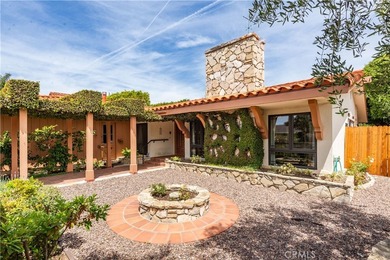A gated courtyard entry sets the tone for this charming - photo 7