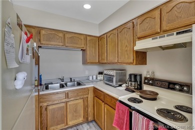 This 3-bedroom, 2-bath home on Nonsuch in Lake Ozark is now - photo 16