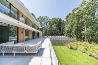 Set amidst lush greenery in one of the Hamptons' most serene - photo 27