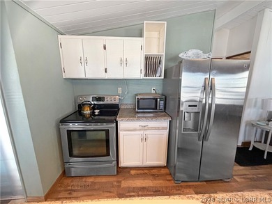 Enjoy the ease of lake living in this updated home with a swim - photo 4