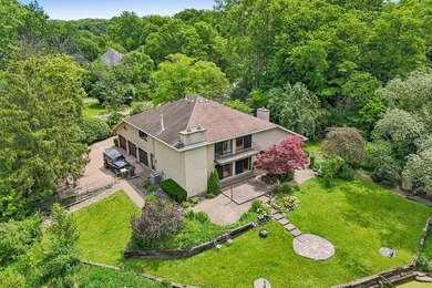 This contemporary 5-bedroom, 2.5-bath home sits on 1.4 wooded - photo 2