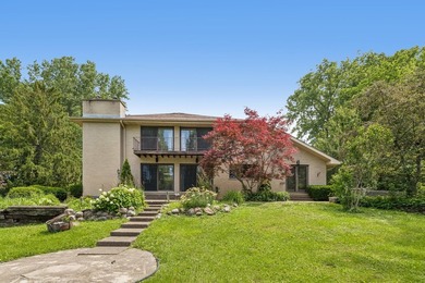 This contemporary 5-bedroom, 2.5-bath home sits on 1.4 wooded - photo 3