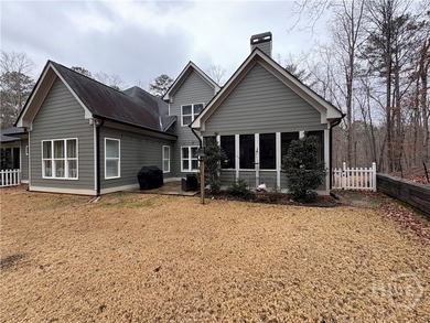 Tucked away on a serene two-acre wooded lot, this stunning