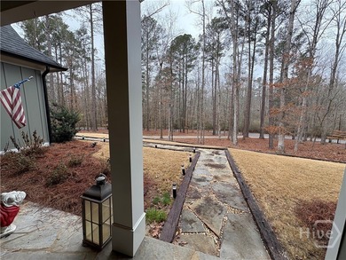 Tucked away on a serene two-acre wooded lot, this stunning