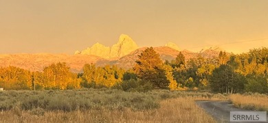 Set beneath wide-open skies with the Tetons rising in the - photo 3