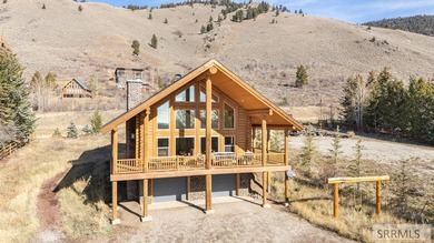 Perched on a half-acre of pristine land, this full-log retreat - photo 1