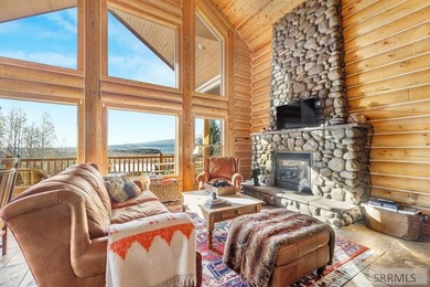 Perched on a half-acre of pristine land, this full-log retreat - photo 2