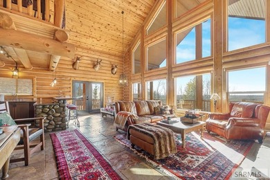 Perched on a half-acre of pristine land, this full-log retreat - photo 3