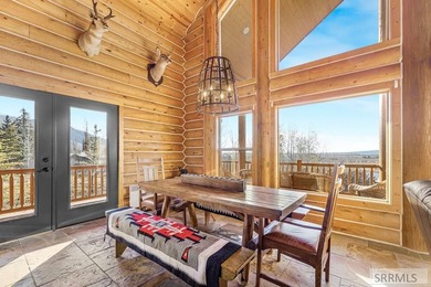 Perched on a half-acre of pristine land, this full-log retreat - photo 5
