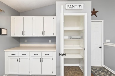 This brick ranch home sits in a peaceful wooded area at the end