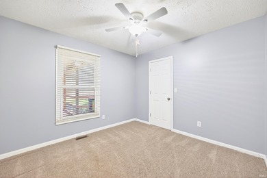 This brick ranch home sits in a peaceful wooded area at the end