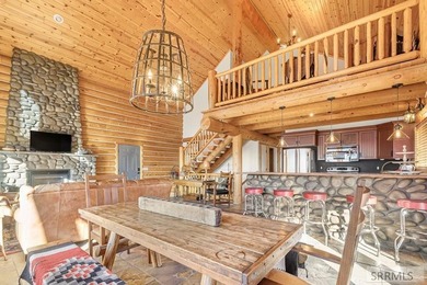 Perched on a half-acre of pristine land, this full-log retreat - photo 7