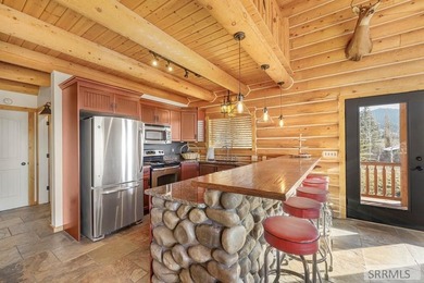 Perched on a half-acre of pristine land, this full-log retreat - photo 8