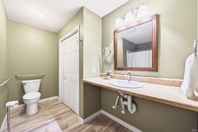 This brick ranch home sits in a peaceful wooded area at the end