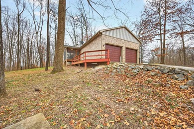 This brick ranch home sits in a peaceful wooded area at the end