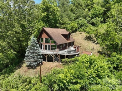 Escape to this warm and inviting 1.5-story mountain home set on - photo 2