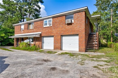 Solid and low-maintenance, this all-brick triplex sits in Garden - photo 21