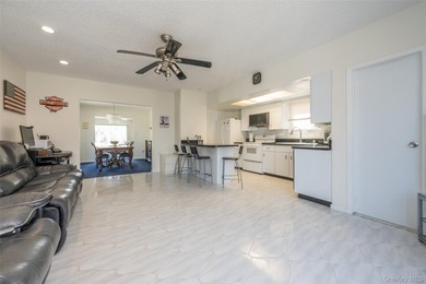 Deceptive from the outside, this expanded Colonial home offers - photo 2