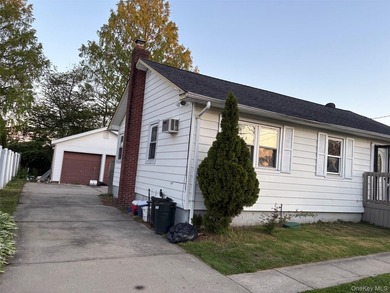The home features a large driveway, a two-car garage, stainless - photo 12