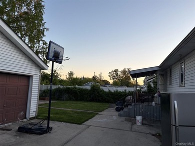 The home features a large driveway, a two-car garage, stainless - photo 15