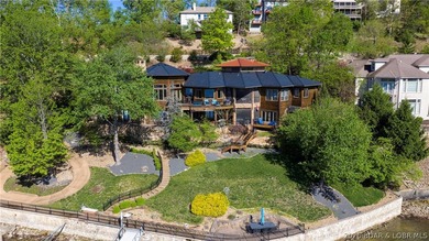 Lodge-style lakefront retreat sitting on over 1 acre with an - photo 3