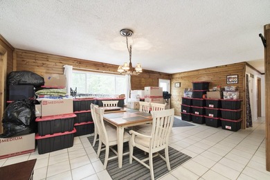 With its knotty pine wood finishes and tree shaded setting, this