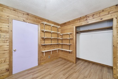 With its knotty pine wood finishes and tree shaded setting, this