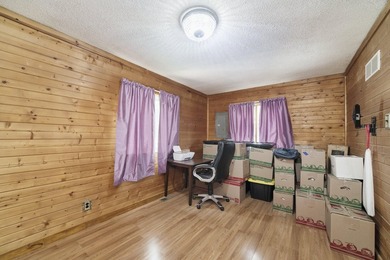 With its knotty pine wood finishes and tree shaded setting, this