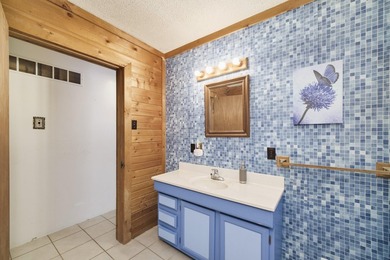 With its knotty pine wood finishes and tree shaded setting, this