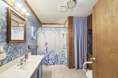 With its knotty pine wood finishes and tree shaded setting, this