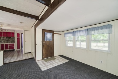 With its knotty pine wood finishes and tree shaded setting, this