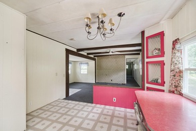 With its knotty pine wood finishes and tree shaded setting, this