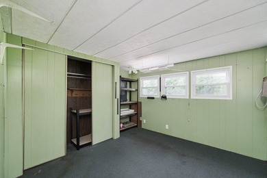 With its knotty pine wood finishes and tree shaded setting, this