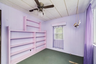 With its knotty pine wood finishes and tree shaded setting, this