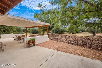 With a gorgeous backdrop of Granite Mountain, this Prescott home