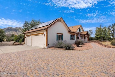 With a gorgeous backdrop of Granite Mountain, this Prescott home