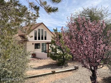 With a gorgeous backdrop of Granite Mountain, this Prescott home