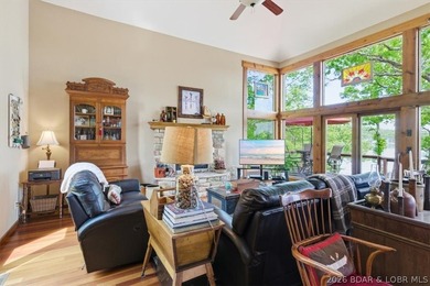 Vaulted ceilings, walls of windows, and wood-burning fireplace - photo 8