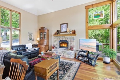 Vaulted ceilings, walls of windows, and wood-burning fireplace - photo 9